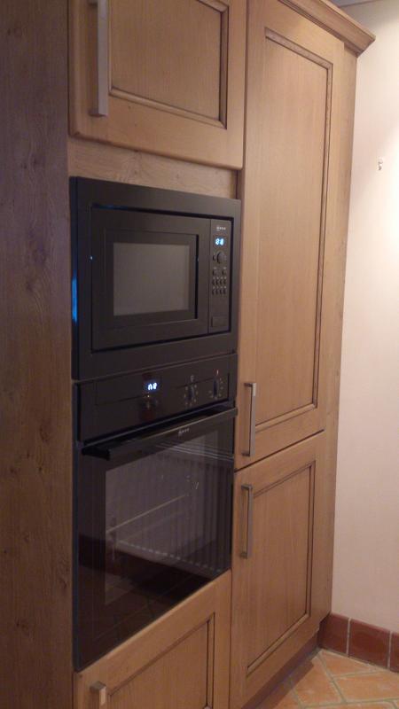 Dales Knotty Oak kitchen fitted with Encore worktops, travertine wall tiles and terracotta floor tiles