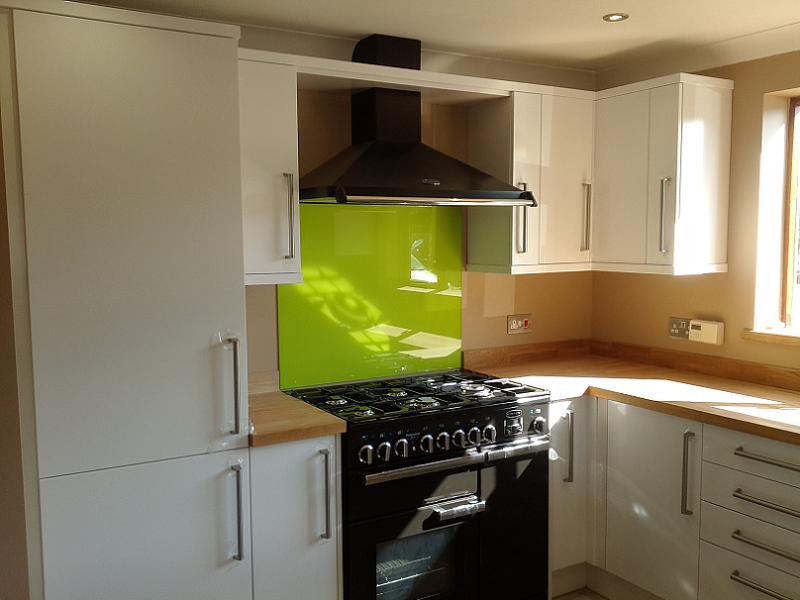 Logica White Gloss kitchen fitted with oak worktops