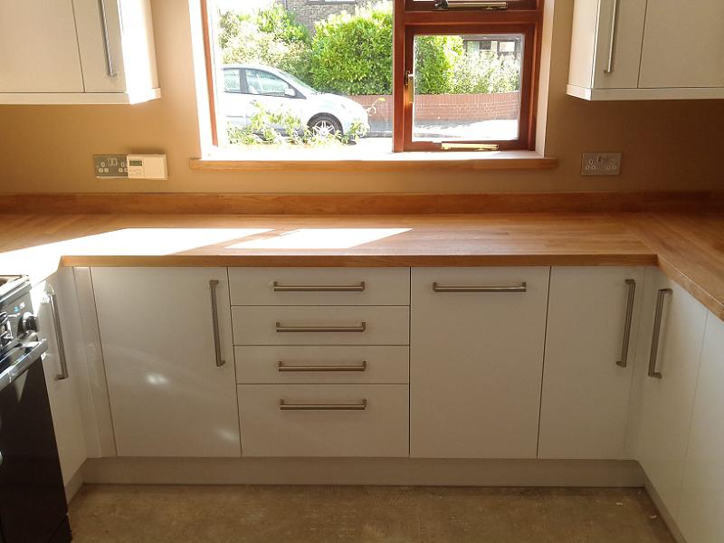 Logica White Gloss kitchen fitted with oak worktops