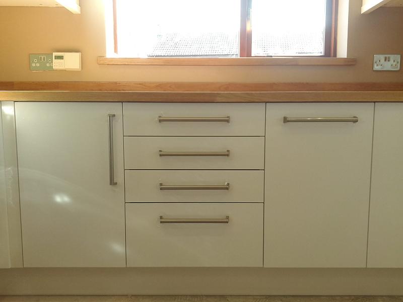 Logica White Gloss kitchen fitted with oak worktops