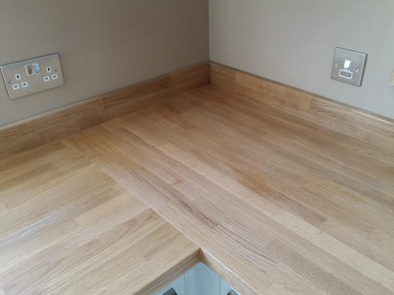 Logica White Gloss kitchen fitted with oak worktops