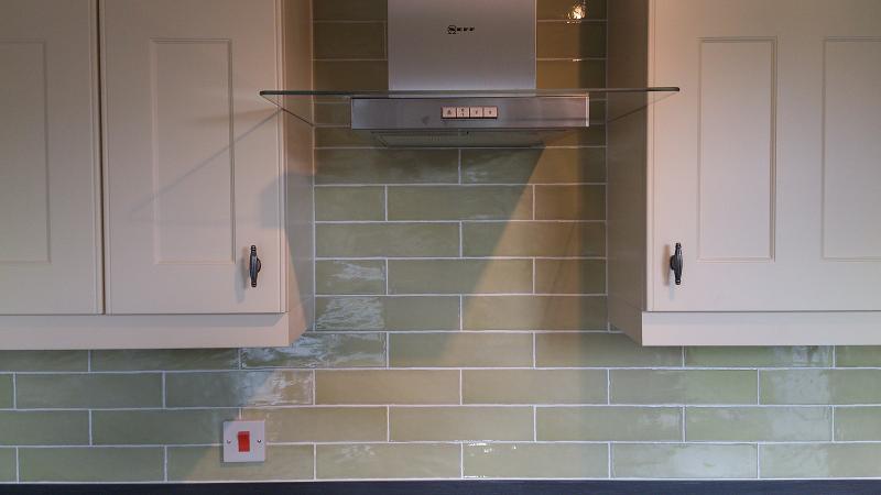 Optima T-bar Buttermilk kitchen fitted in Lowestoft with laminate worktops and pistachio wall tiles