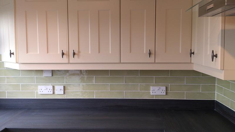 Optima T-bar Buttermilk kitchen fitted in Lowestoft with laminate worktops and pistachio wall tiles