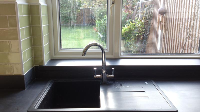 Optima T-bar Buttermilk kitchen fitted in Lowestoft with laminate worktops and pistachio wall tiles