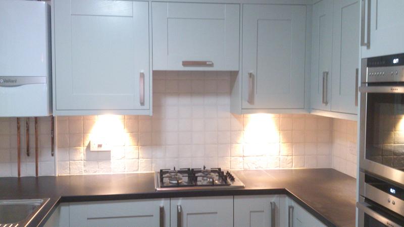 Shaker Wood Blue kitchen fitted with laminate worktops