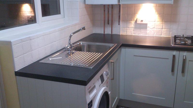 Shaker Wood Blue kitchen fitted with laminate worktops