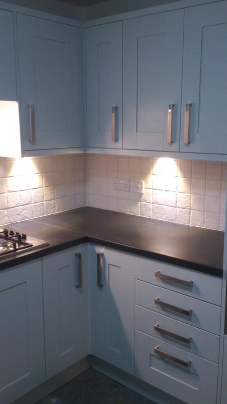 Shaker Wood Blue kitchen fitted with laminate worktops