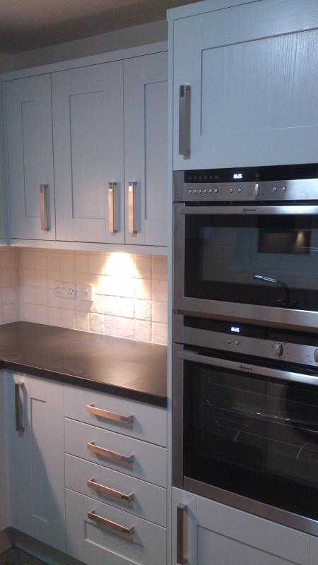 Shaker Wood blue kitchen fitted with laminate worktops