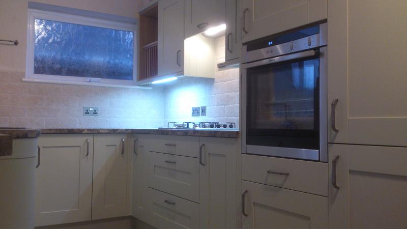 Shaker Wood Blue kitchen fitted with laminate worktops