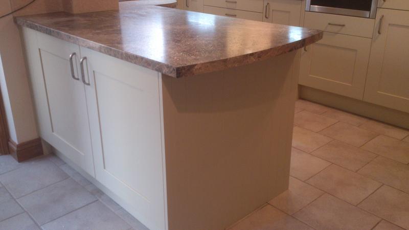 Shaker Wood Blue kitchen fitted with laminate worktops