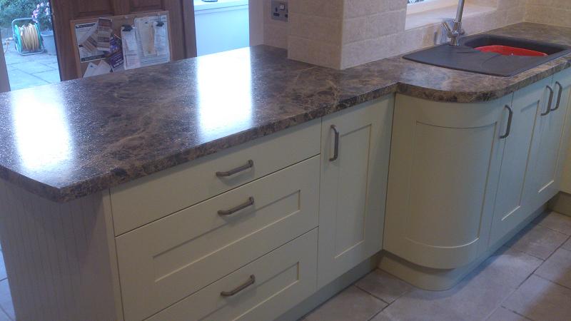 Shaker Wood Blue kitchen fitted with laminate worktops