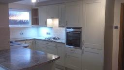 Shaker Wood Blue Kitchen fitted with laminate worktops